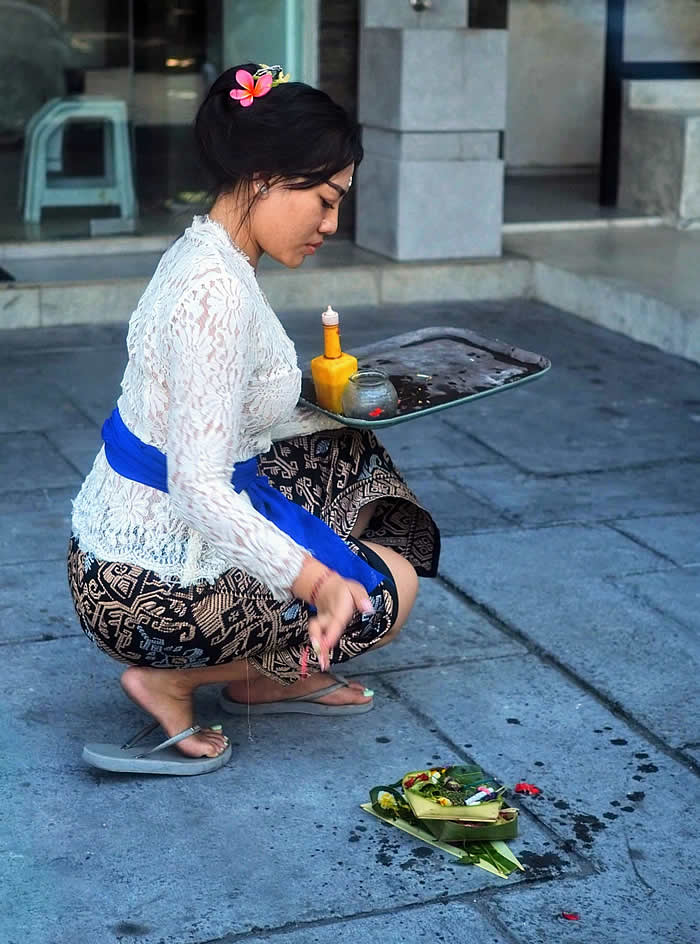Women in Bali, a woman making canang sari ceremony